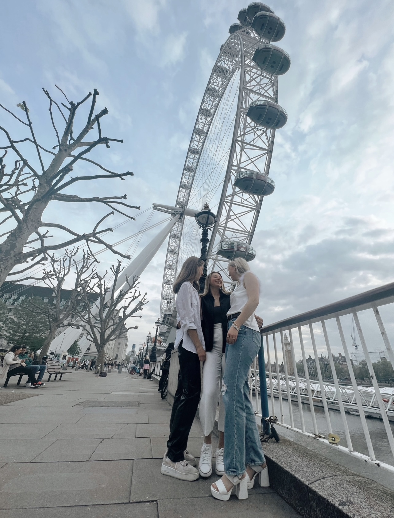 Isabella and two other women standing in front of London Eye.