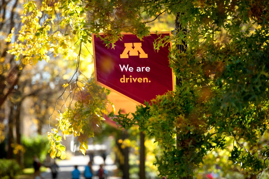 Photo of We are Drive banner among the trees on campus