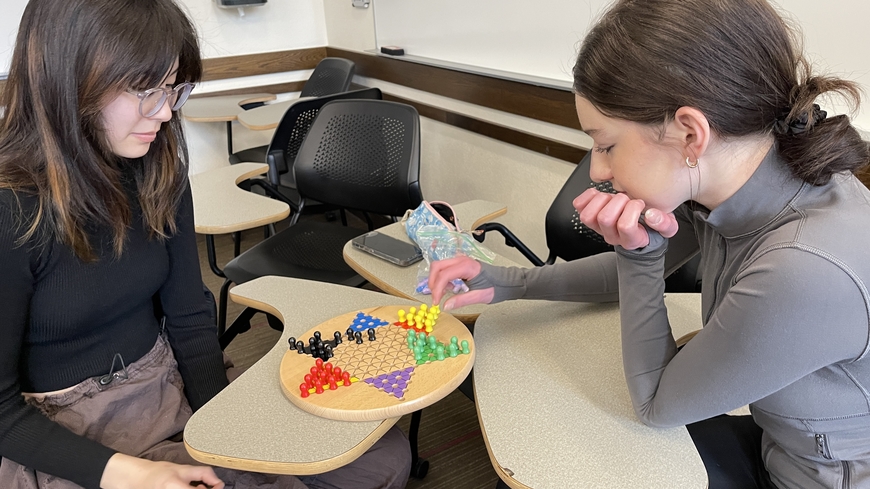 Two students play Chinese checkers