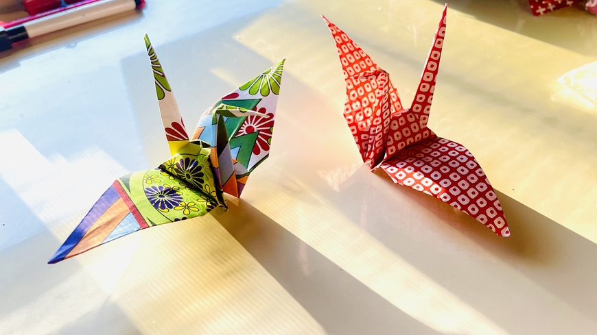 Two colorful paper cranes