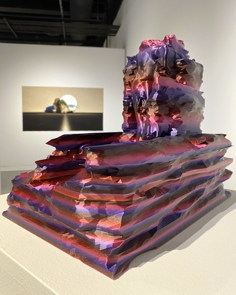 Pink and purple striped sculpture on pedestal