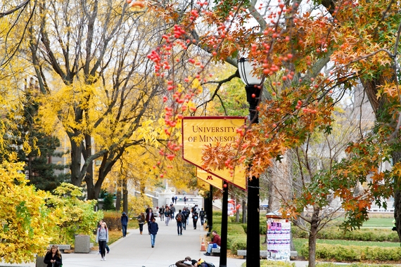 The Mall in fall, with a University of Minnesota flag on a lamppost in the center