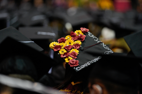 Graduation cap adorned with maroon and gold flowers