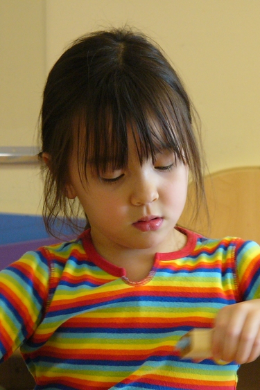 Ellie in a rainbow striped shirt