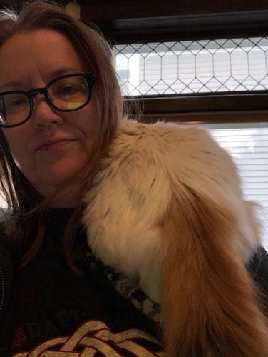 Photo of English staffer Holly Vanderhaar with cat on her shoulder