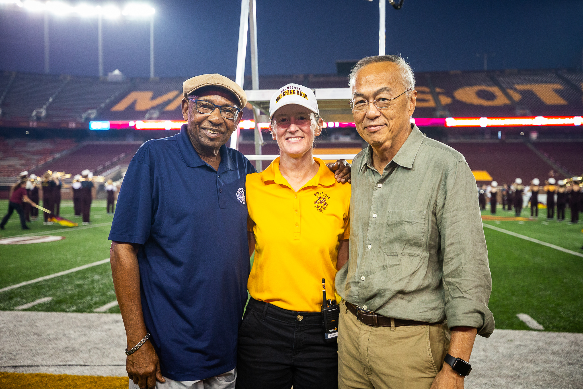 Sanford poses with Marching Band Director Betsy McCann and David Moy