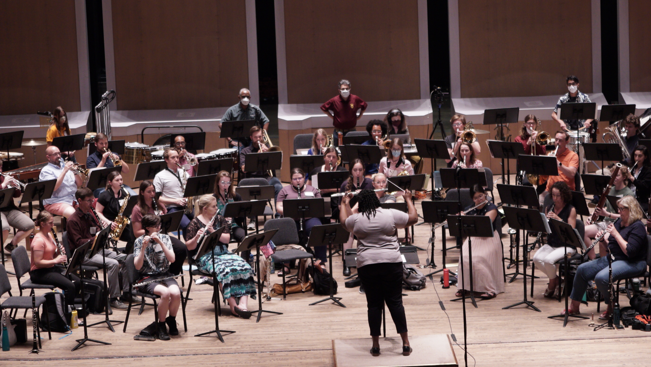 A participant leads the Wind Band Conducting Workshop band in practice of their conducting skills