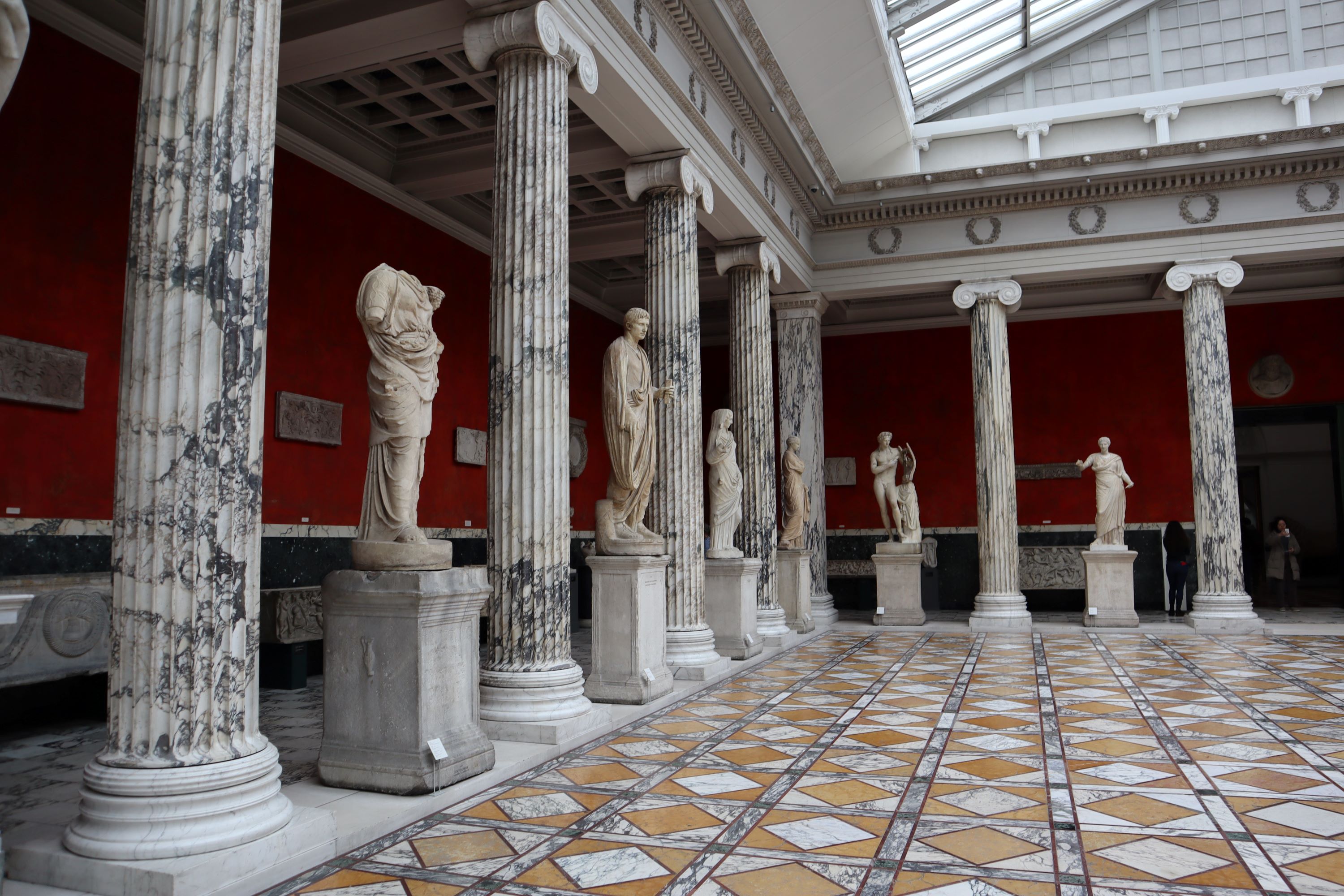 Ancient Greek style statues and columns.