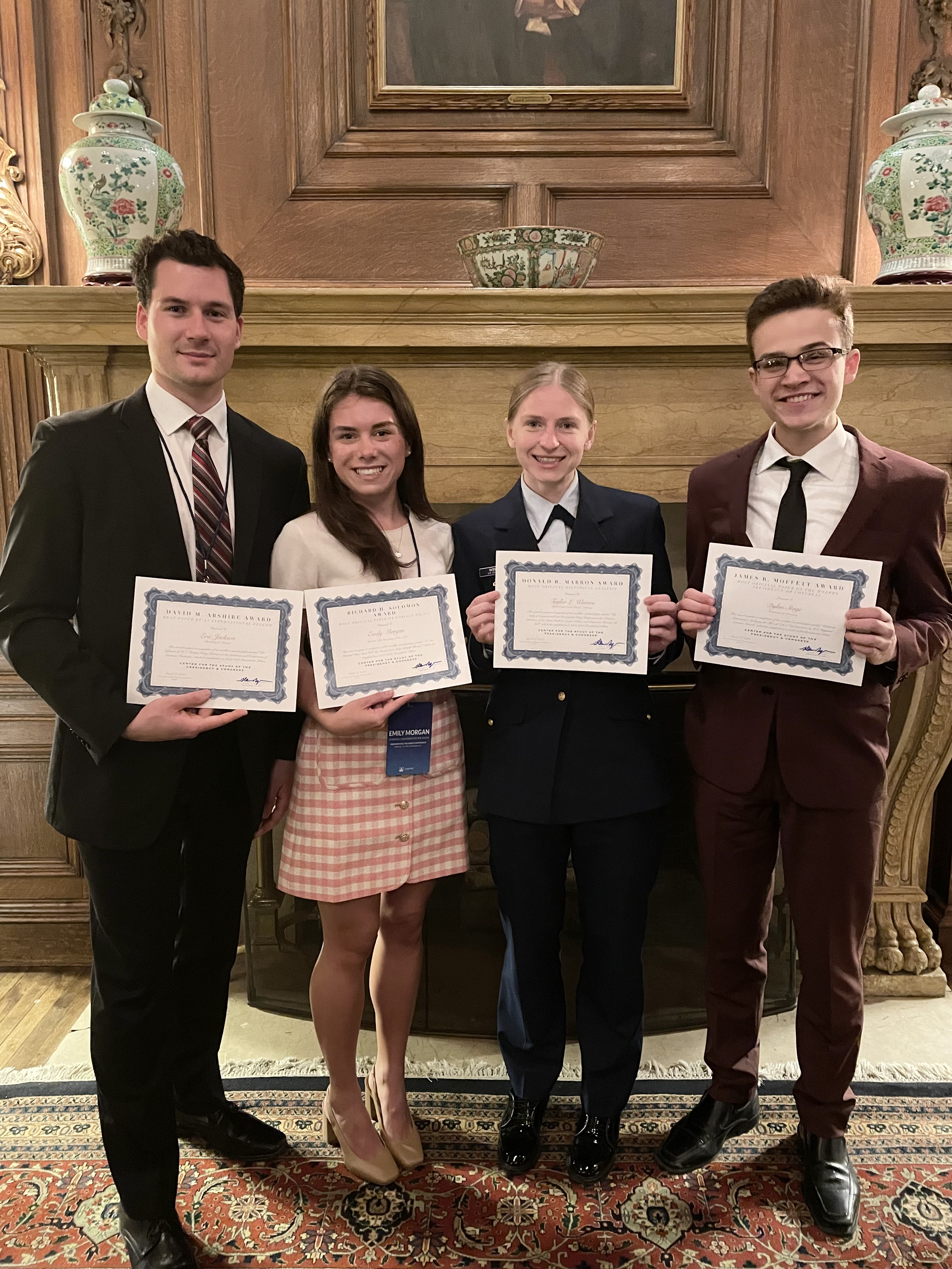 Dylan Stage and other Presidential Fellows holding paper awards.