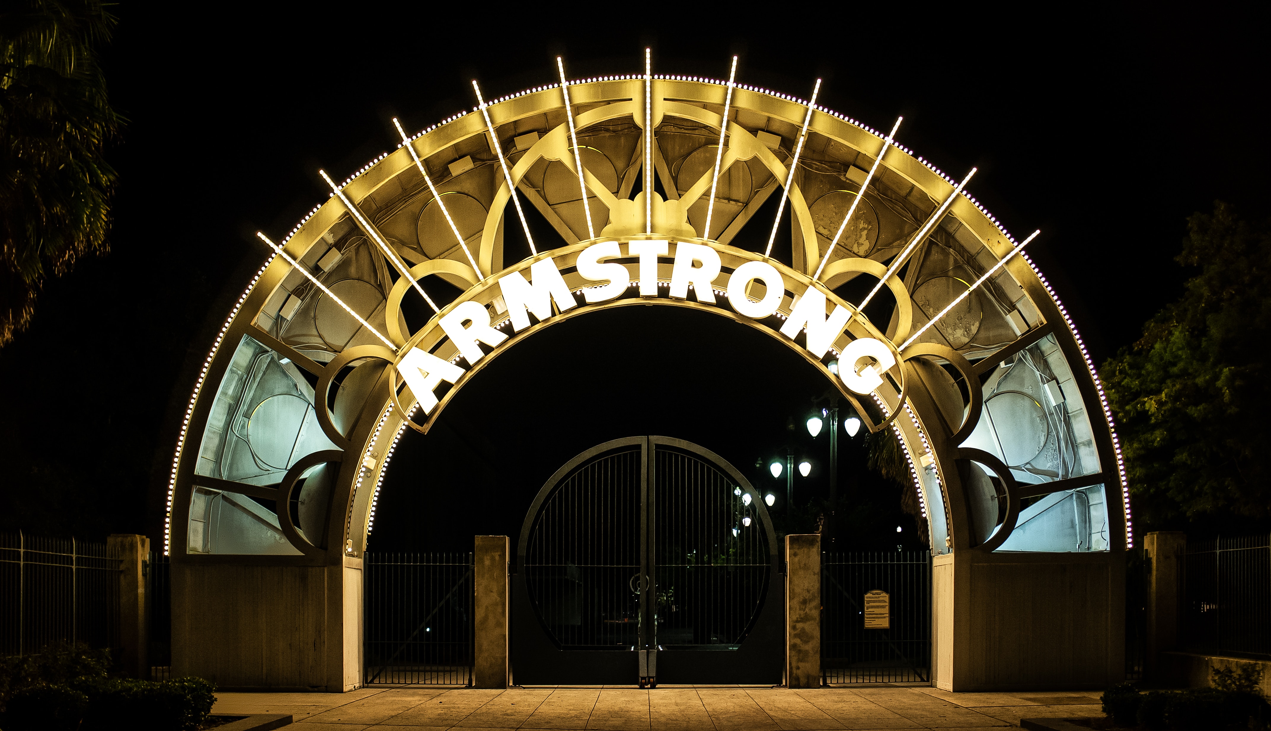 An illuminated archway to Louis Armstrong Park, located in New Orleans, Lousiana