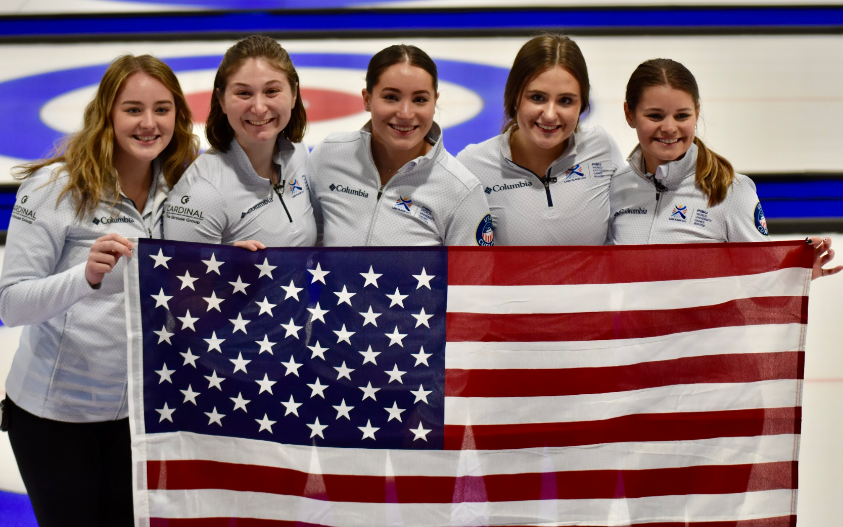 Sydney Mullaney and teammates holding American flag.
