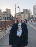 photo of woman with blonde hair on the stone arch bridge
