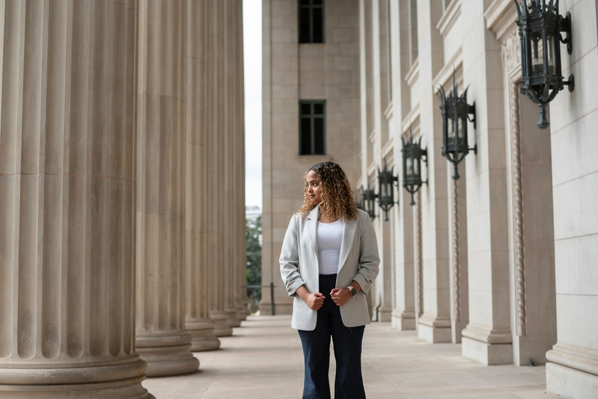 Yusra Hassan stands in front of the columns outside Northrop Auditorium