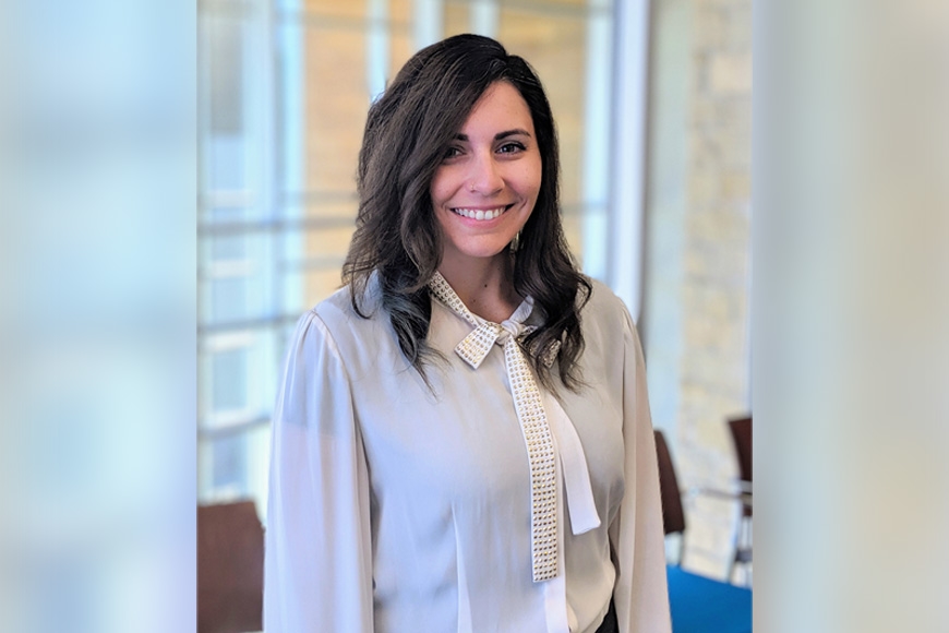 Alexa Mayerhofer, wearing a white shirt, smiles at the camera