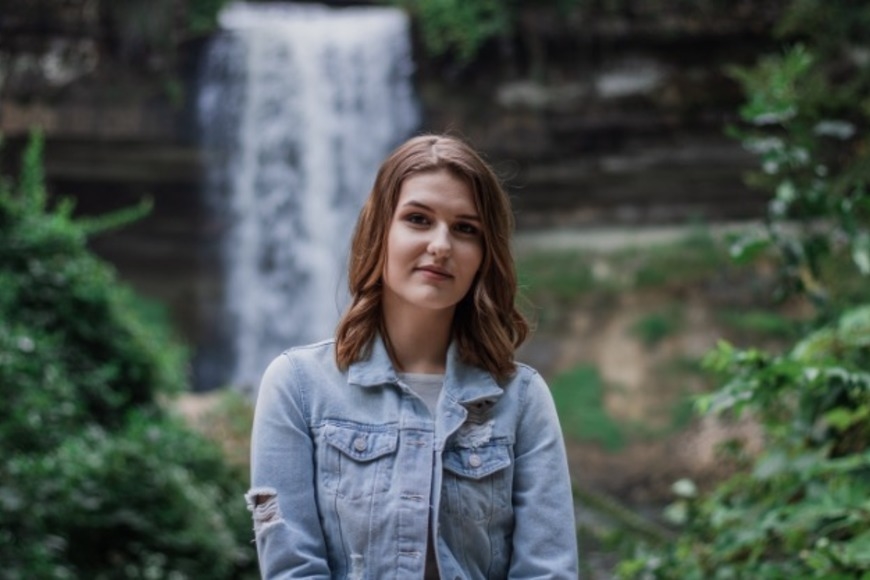 Cassidy Fox standing in front of a waterfall