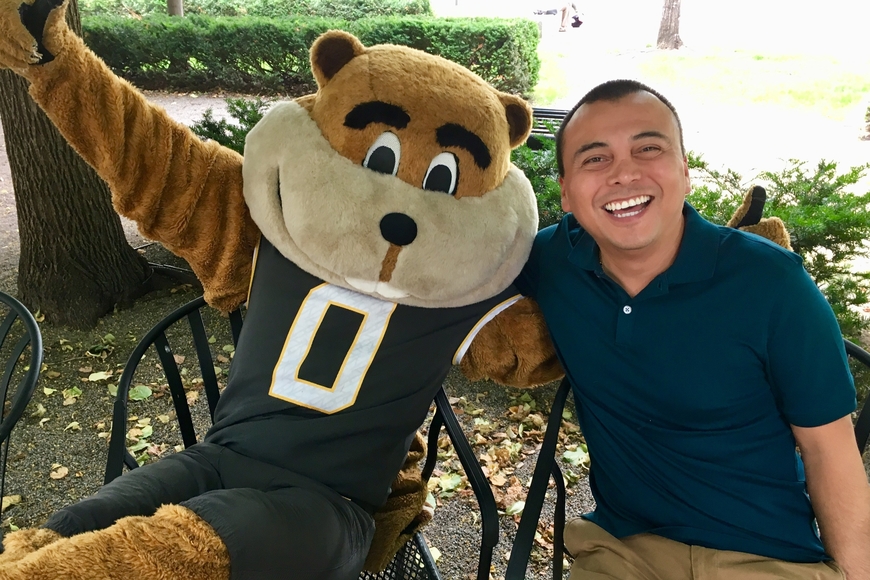 Dr. Adolfo Carillo Cabello sitting outside with Goldy.