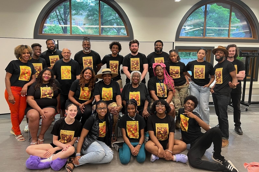 The multigenerational cast of Kumbayah The Juneteenth Story poses in the Hub wearing Kumbayah branded t-shirts.