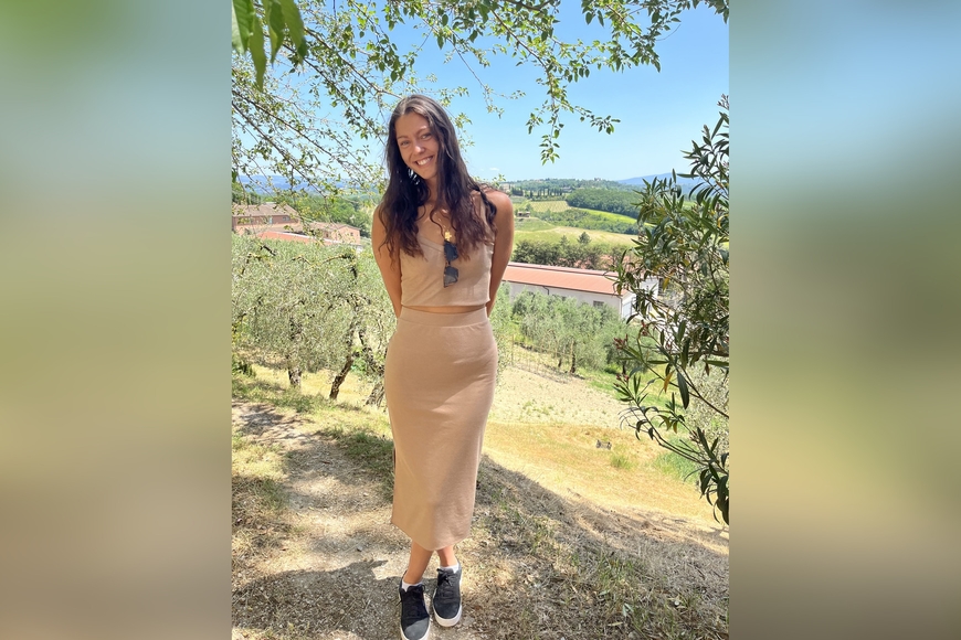 Marina Rajkovic standing underneath a tree with her arms behind her back
