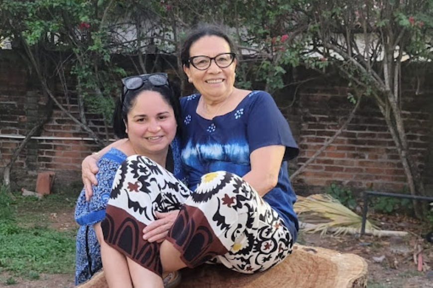 Paula Cuellar Cuellar (standing) with Neris Gonzalez (seated), whose story was featured in the film Añil.