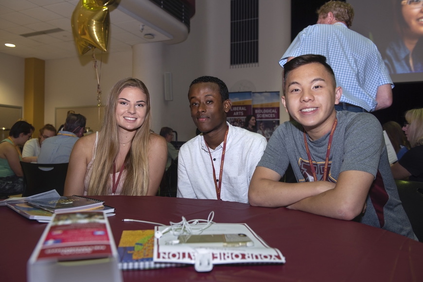 Three students at a table during Orientation