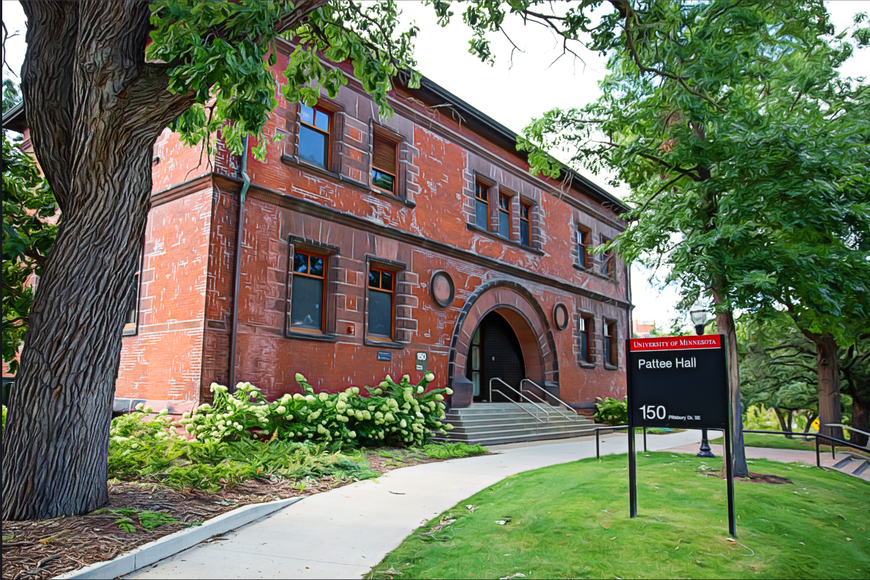 Portrait of a two-story red brick building, shot from the left side, pointing at the arched main entrance. The building has a cement walking path and stairs leading up to the entrance door. There is a black sign that says 'Pattee Hall' with a maroon 'University of Minnesota' banner above the building name.