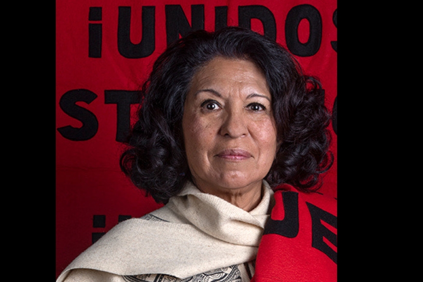 Photo of Ramona Rosales with a red flag behind her that says "Unidos"