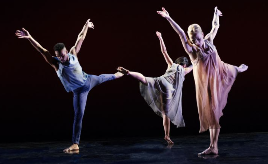 3 dancers standing on one leg each with arms reaching upwards