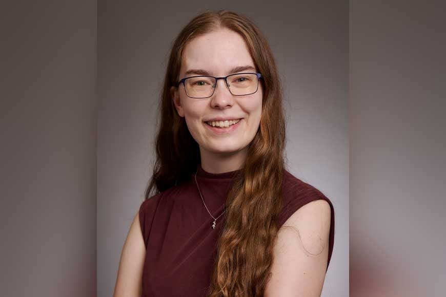 Allison Obright sitting before a grey background