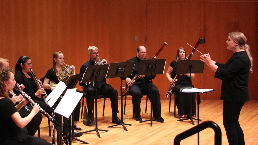 A group of musicians perform in a chamber group. 