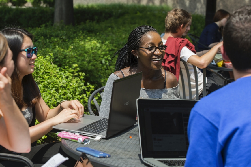 Students studying together outdoors on campus