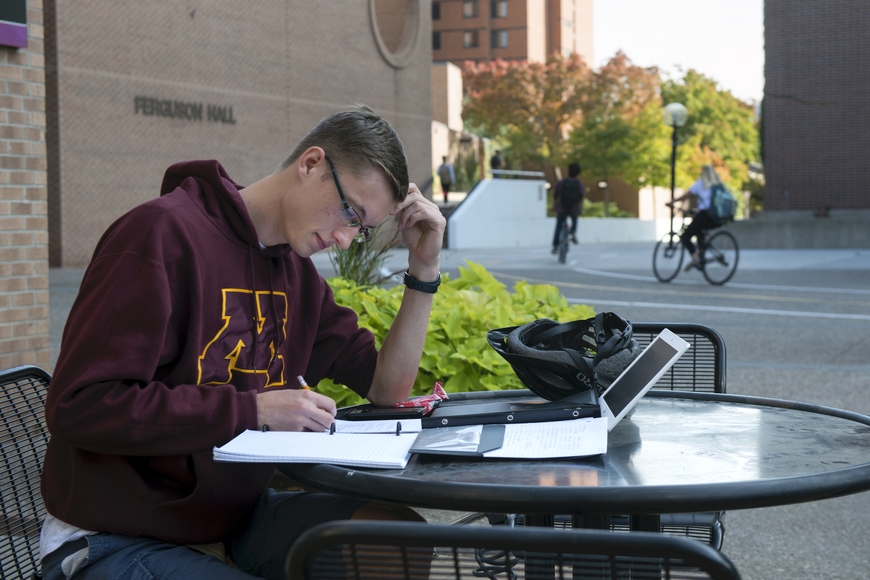 Student studying outside Ferguson Hall