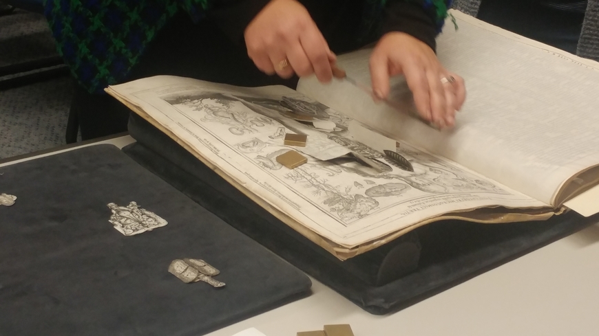 Dr. Suzanne Karr-Schmidt (Newberry Library) handles a copy of Johannes Remmelin's 17th-century flap anatomy text, "Catoptrum Microcosmicum," at the Wangensteen Library.