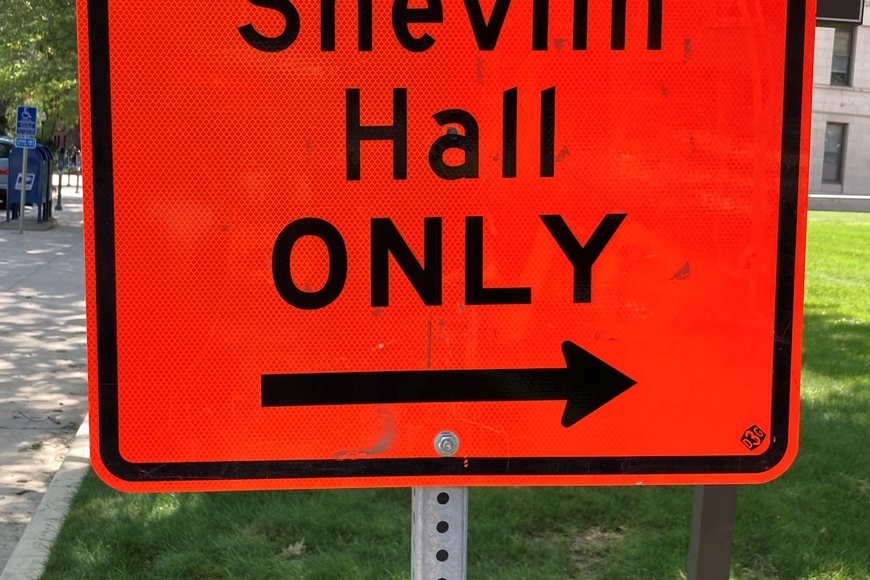 picture of a street sign that says "Access to Shevlin Hall Only with an arrow to the entrance of Shevlin hall.