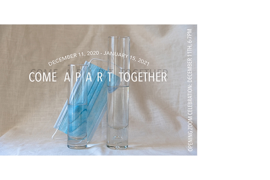 Photograph of two narrow vials of water with a disposable paper mask resting in the background behind them.