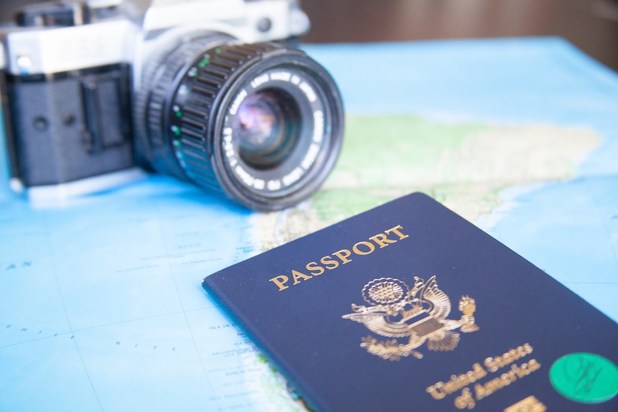 camera and passport on map