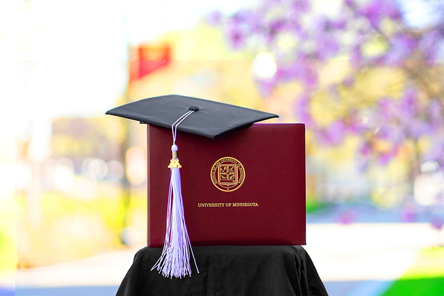 Cap, tassel and diploma cover on Northrop Mall