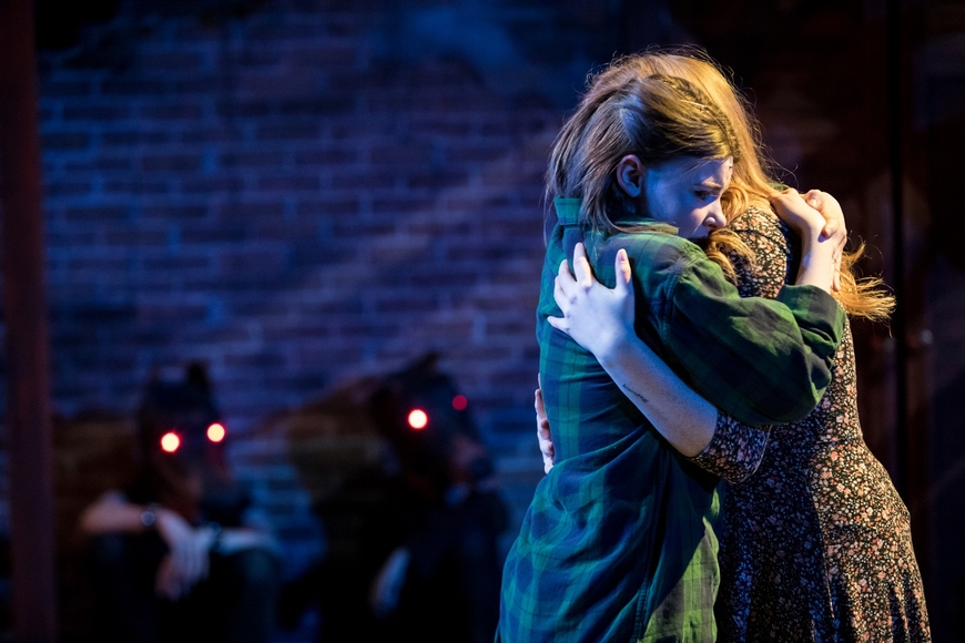 Photo of two characters hugging from a stage production of The Skriker