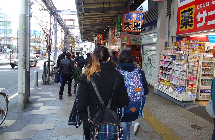 Image of student Samantha Keo on visit to Japan, walking down a street