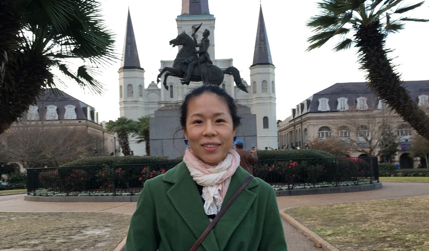 Photo of PhD candidate Bomi Jeon (head and shoulders) in front of castle, turrets, and statue of man riding horse