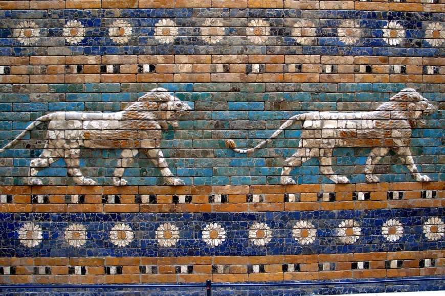 Mosaic of a lion walking in front of a teal background