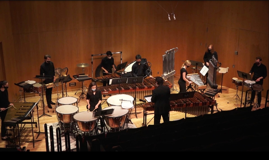 Percussionists performing in a group on stage
