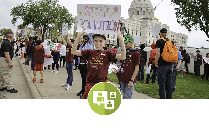 Child holding "Stop Pollution" sign at the state Capitol