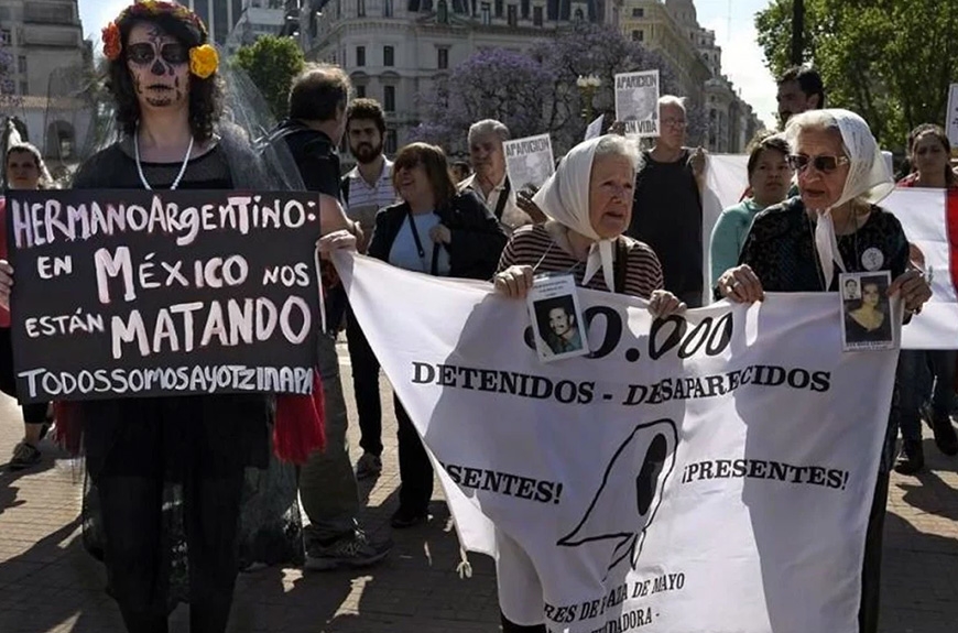 Women at protest in Mexico holding signs