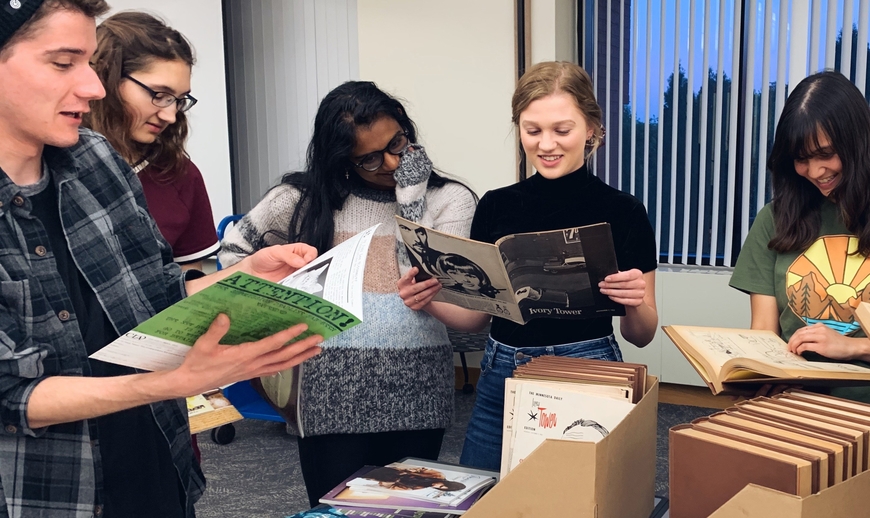 Undergraduate students looking at Tower literary magazine archives