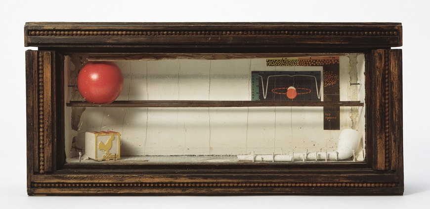 Photo of work of art by Joseph Cornel showing object inside a wooden box with a glass top.