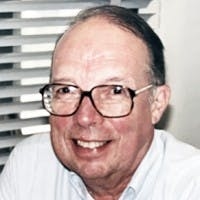 Bill Flanigan. Wearing glasses and white button-up shirt.