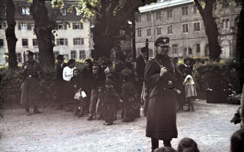 German police stand guard at an assembly point in Hohenasperg, where Gypsies await deportation to the General Government in Poland.