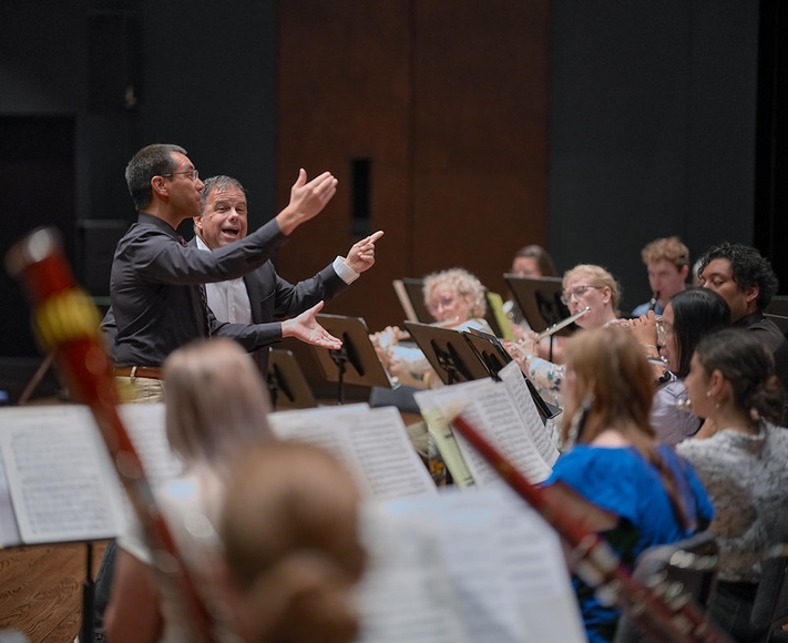 Guest conductor Dr. Robert Ambrose works with a participant in the Wind Band Conducting Workshop