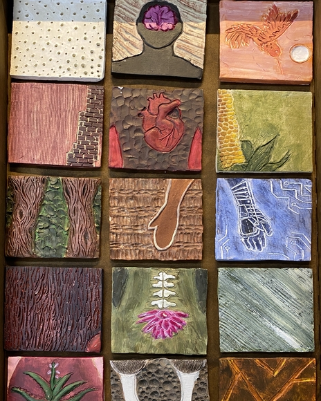 Ceramic tiles showing different stylized body parts in a grid