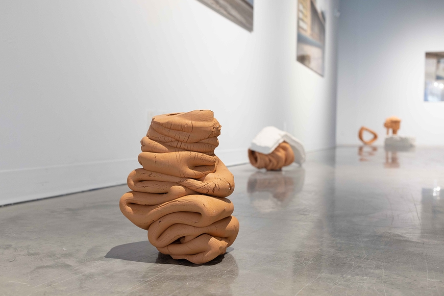 Light brown ceramic sculpture on the gallery floor, by Cody Hilleboe MFA 2022